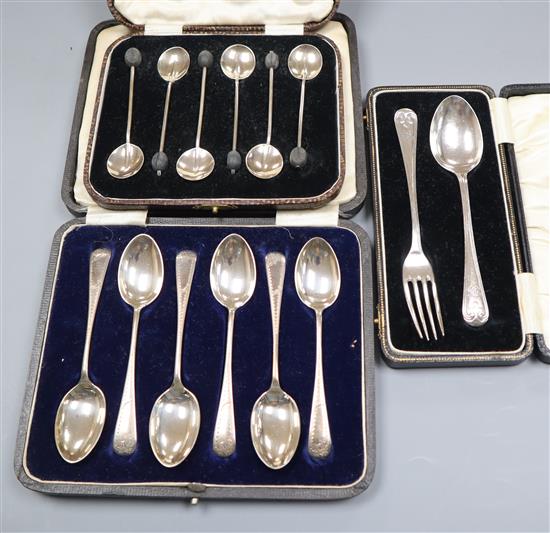 Three assorted cased sets of silver flatware including a christening pair and coffee spoons.